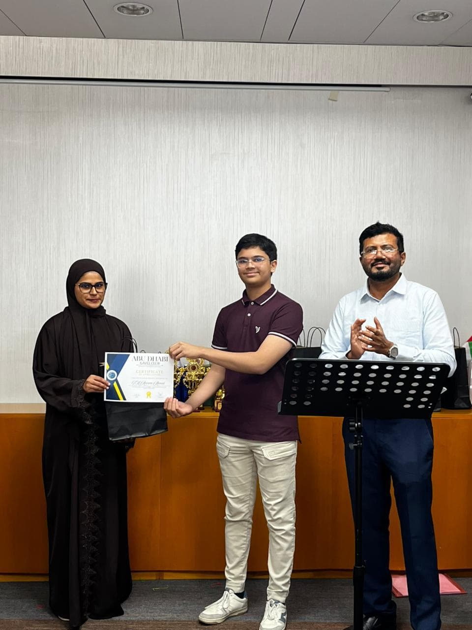A member receiving a certificate at a club award ceremony