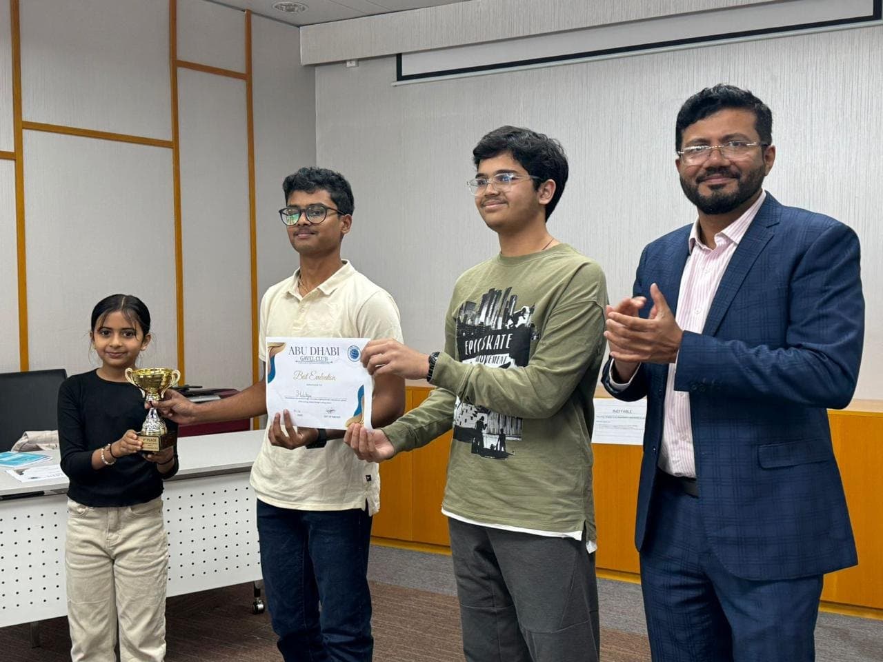 Members receiving the Best Evaluation certificate and a trophy